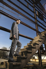 Young Businessman Walking Up Stairs