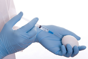 Doctor vaccinating the white egg