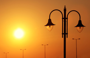 Streetlight lantern at sundown with yellow sky