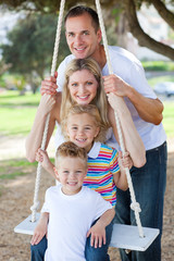 Fototapeta na wymiar Happy family swinging
