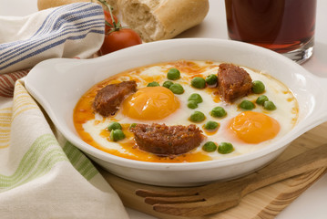 Spanish cuisine. Eggs on vegetables.