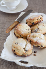 Fruit scones on a ceramic dish with knife