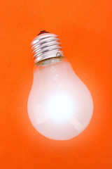 Light bulb on orange background
