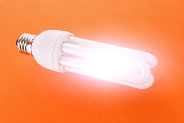 Light bulb on orange background