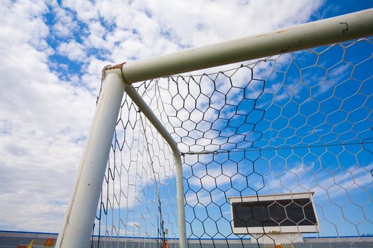 STADIUM - Football field with goal and tablo on blue sky