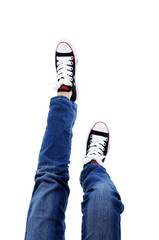 In jeans and sneakers over white background