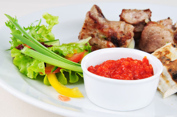 hot sauce and salad to meat platter