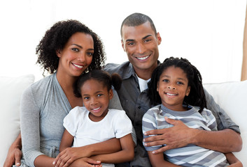 Loving african american family sitting on the sofa together