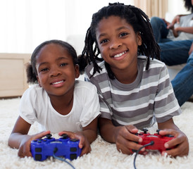 Close-up of siblings playing video game