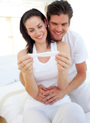 Smiling couple finding out results of a pregnancy test