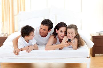 Fototapeta premium Happy family having fun in the bedroom