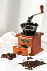 coffee beans and pieces of chocolate with coffee grinders