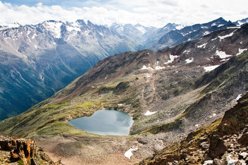 Fototapeta na wymiar Lake in form of a heart. Alps