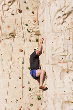 Man Climbing Rock Wall