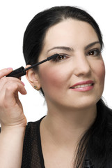 Portrait of woman applying mascara