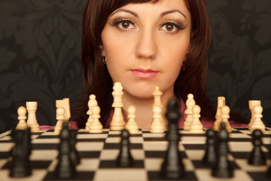 Portrait of girl in red shirt with chessboard.