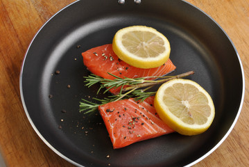 salmon steak with lemon in a pan