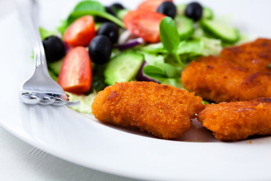Chicken nuggets with salad