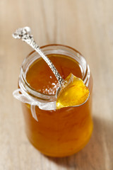 orange   thin cut marmalade or jam on a spoon in a jar