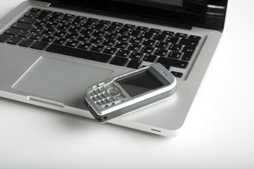 mobile phone over laptop keyboard