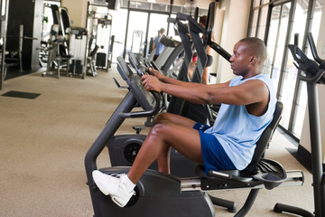Man Exercising On Stationary Cycle