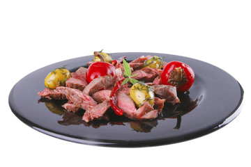 roast meat slices on black dish