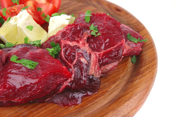 small beef chunks on wooden plate