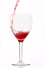 Red wine poured in a glass.