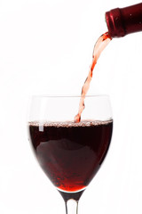 Red wine poured in a glass.