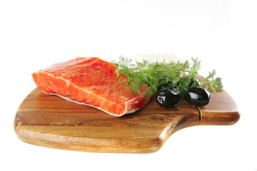 pink salmon on wooden plate with cheese