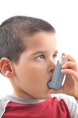 Close up image of a cute little boy using inhaler for asthma