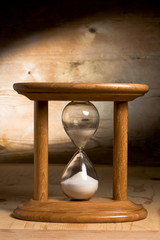 Hourglass on a wooden background