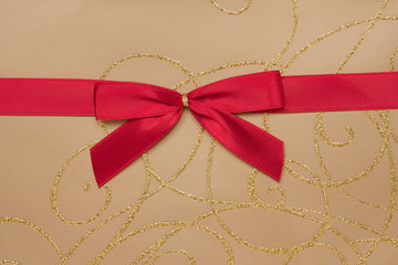 Parcel with gold paper and red ribbon