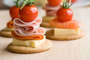 Fototapeta na wymiar Canapes with salmon cheese and salami