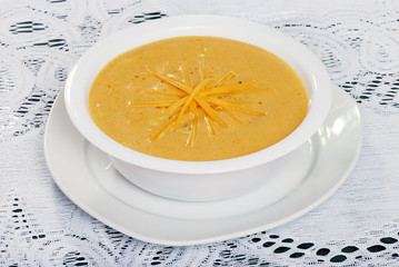 closeup of shredded cheddar cheese soup