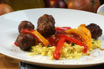 organic rice with grilled meatballs on a plate