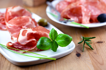 Close up of coppa with fresh herbs