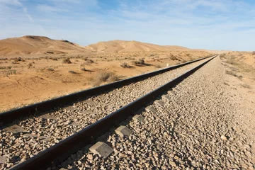 Papier Peint photo moyen-Orient Straight railway in the desert to the horizon