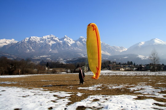 Paragliding on landing in the snow at Dolada mountain