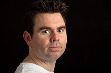 portrait of male in his 30's on black background