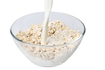 Stream of milk falling in oats flakes
