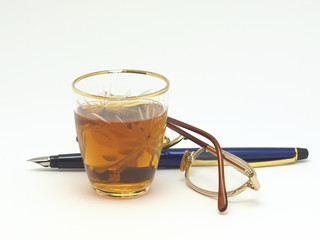 Pen, glasses and wine-glass