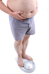 Overweight man with the weight scale