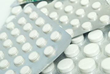 Isolated white pills on white background