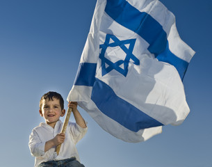 young boy holding the Israeli flag