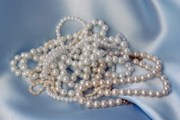 pearls on blue satin background
