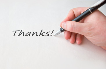 Thanks with hand and black pen over white