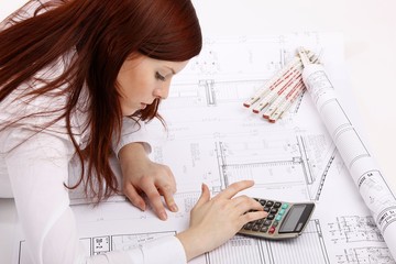 lying woman with house construction plan and calculator