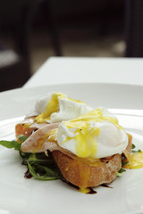 A close-up shot of a chicken and ham egg sandwich