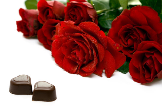 Red rose and chocolate hearts isolated on white